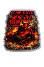 Black t-shirt with red text "Some Days Even The Devil Sits Back And Admires My Work" and devil graphic surrounded by flames, money, and dice.