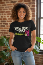 Model wearing a black Bless Your Heart T-shirt with a pink creature graphic.